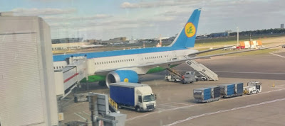 A plane parked on a runway

Description automatically generated